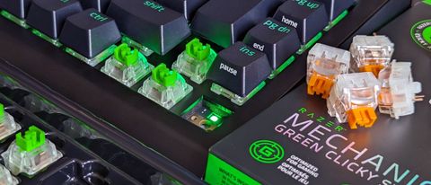 Razer BlackWidow V4 75% keyboard with keycaps removed showing orange and green switches