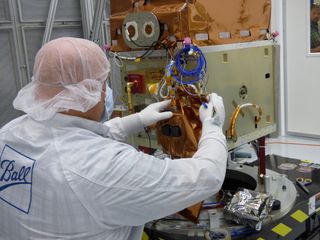A technician works on NASA's Green Propellant Infusion Mission (GPIM) at Ball Aerospace, the prime contractor for the spacecraft.