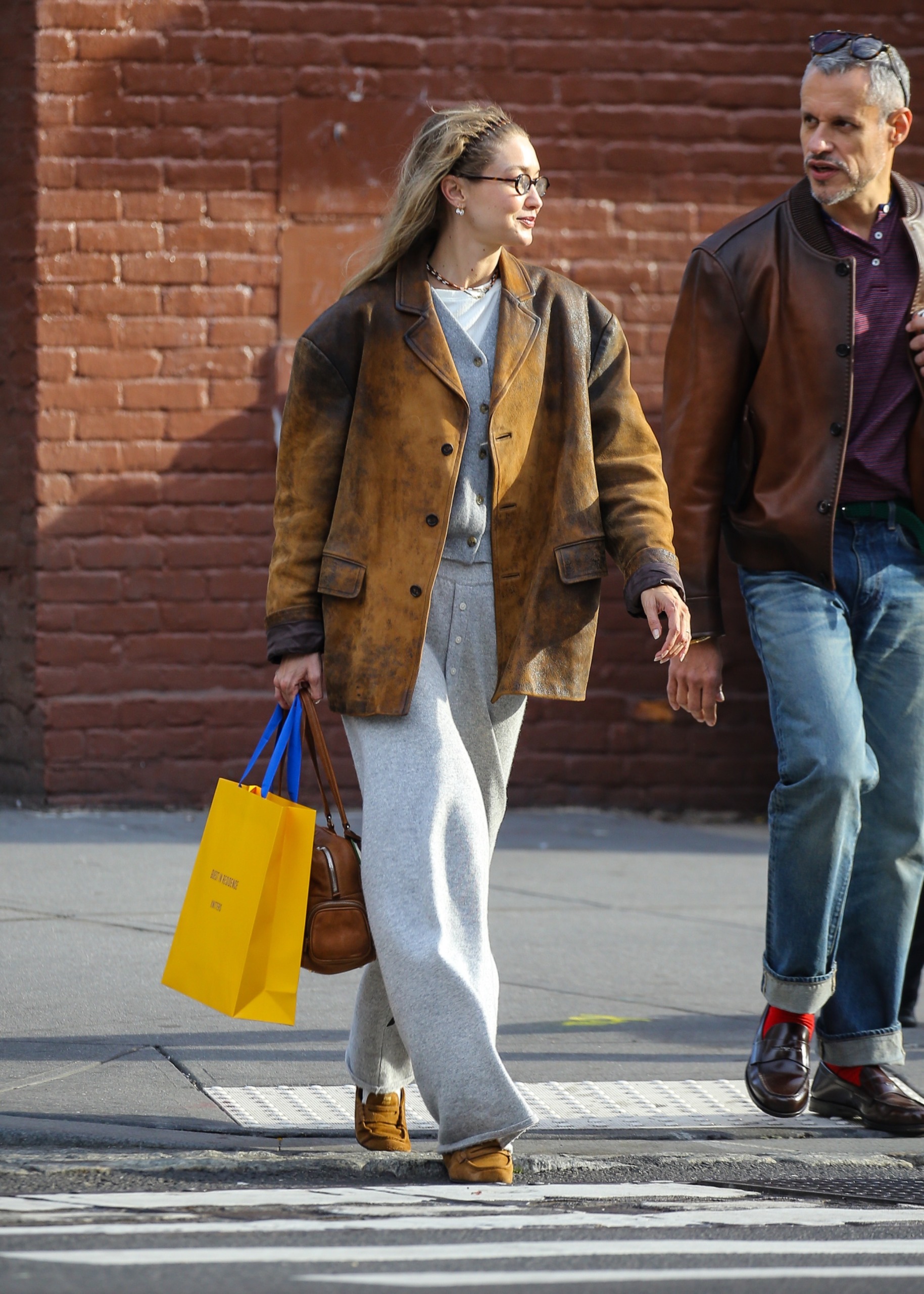 Gigi Hadid wore gray Guest In Residence sweatpants with a leather Miu Miu blazer and the soft loafers trend in suede
