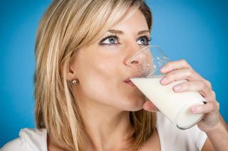 woman drinking a glass of milk