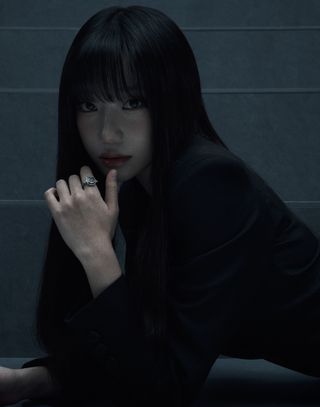 actress and k-pop idol jo yu-ri with bangs and in a black blazer posing with her hand by her mouth