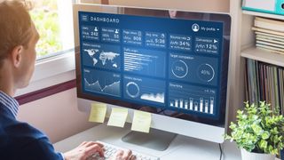 Man looking at audience graphs on a Mac