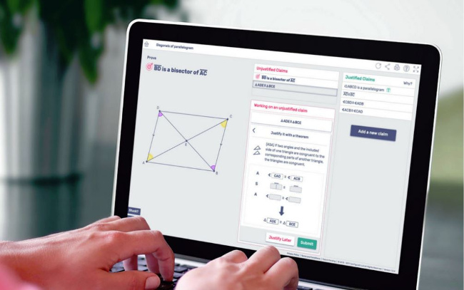 Student hands working at laptop computer with geometry problem on screen
