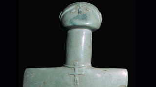 greenish carved stone figurine