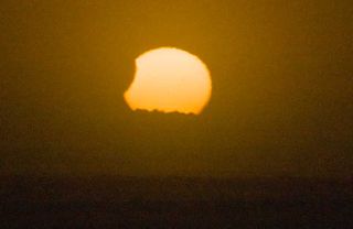 Skywatcher Mike Nicholson took this photo of the Nov. 25 partial solar eclipse from Otaki Beach, New Zealand.