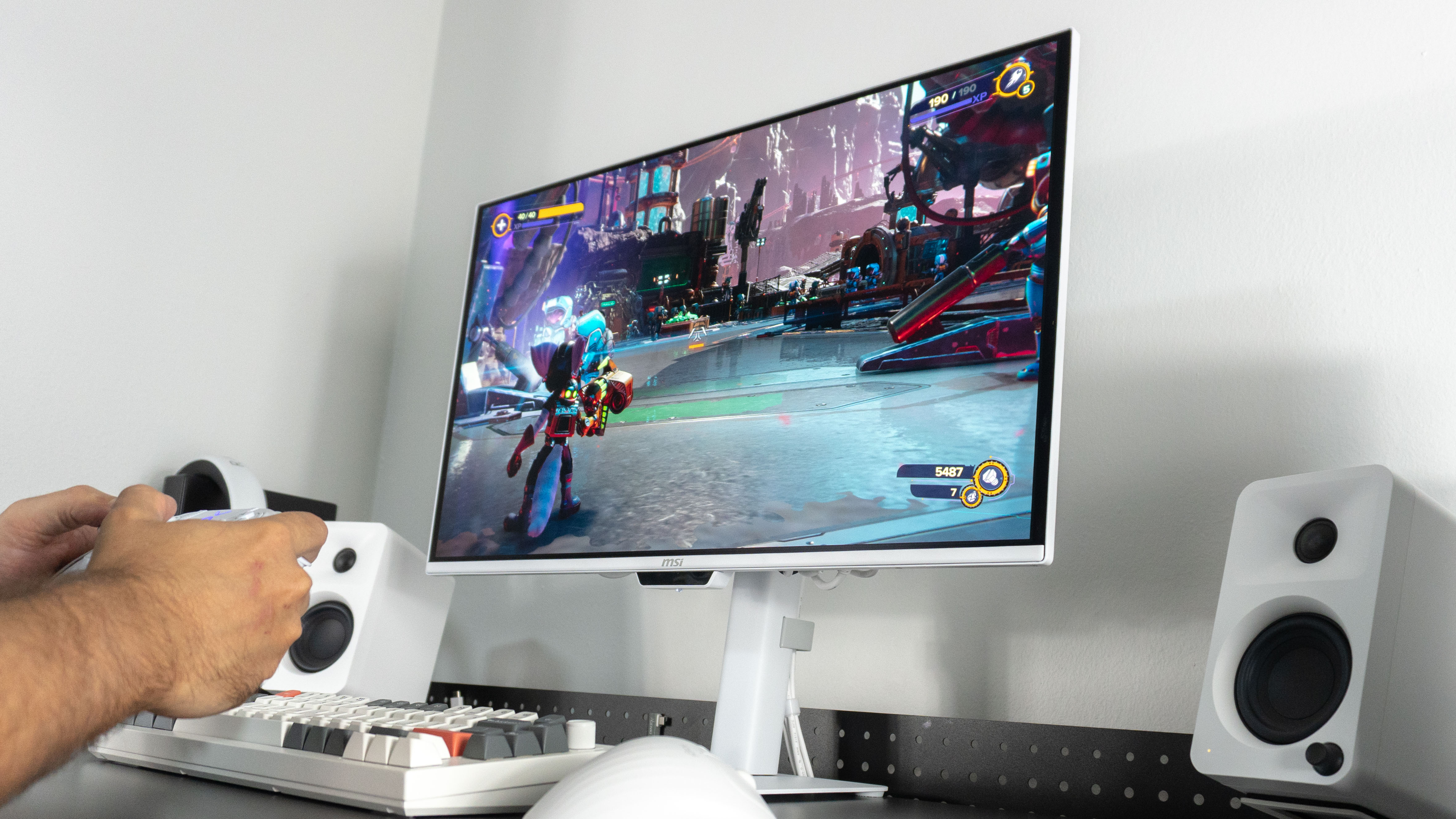 A person playing PC games on the MSI Pro Max 271UPXW12G monitor