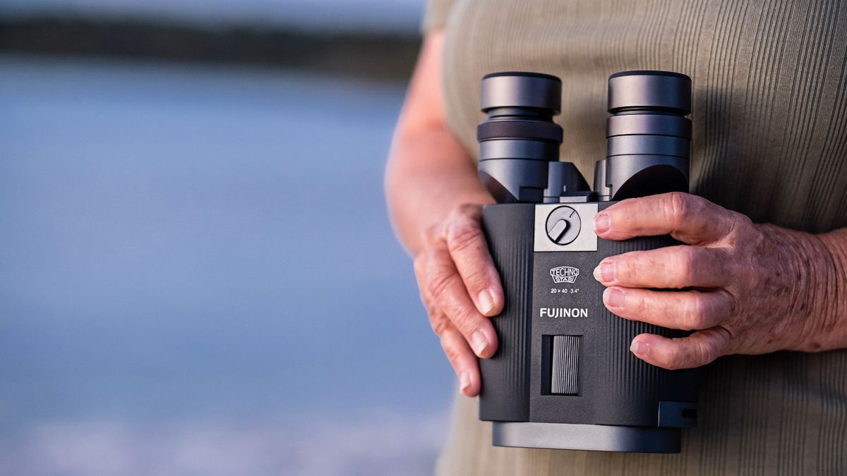 Closeup of a person holding Fujinon TS-L 2040 binoculars