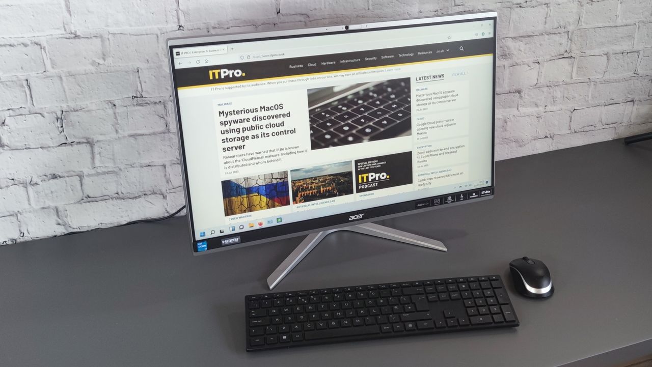A photograph of the Acer Aspire C24 on a desk with mouse and keyboard