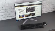 A photograph of the Acer Aspire C24 on a desk with mouse and keyboard