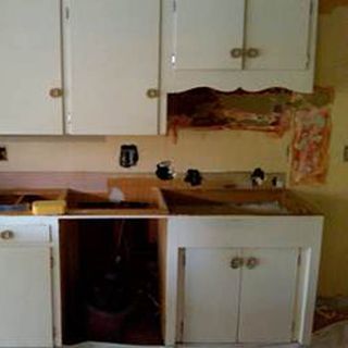 kitchen room with cream wall and white kitchen shelves