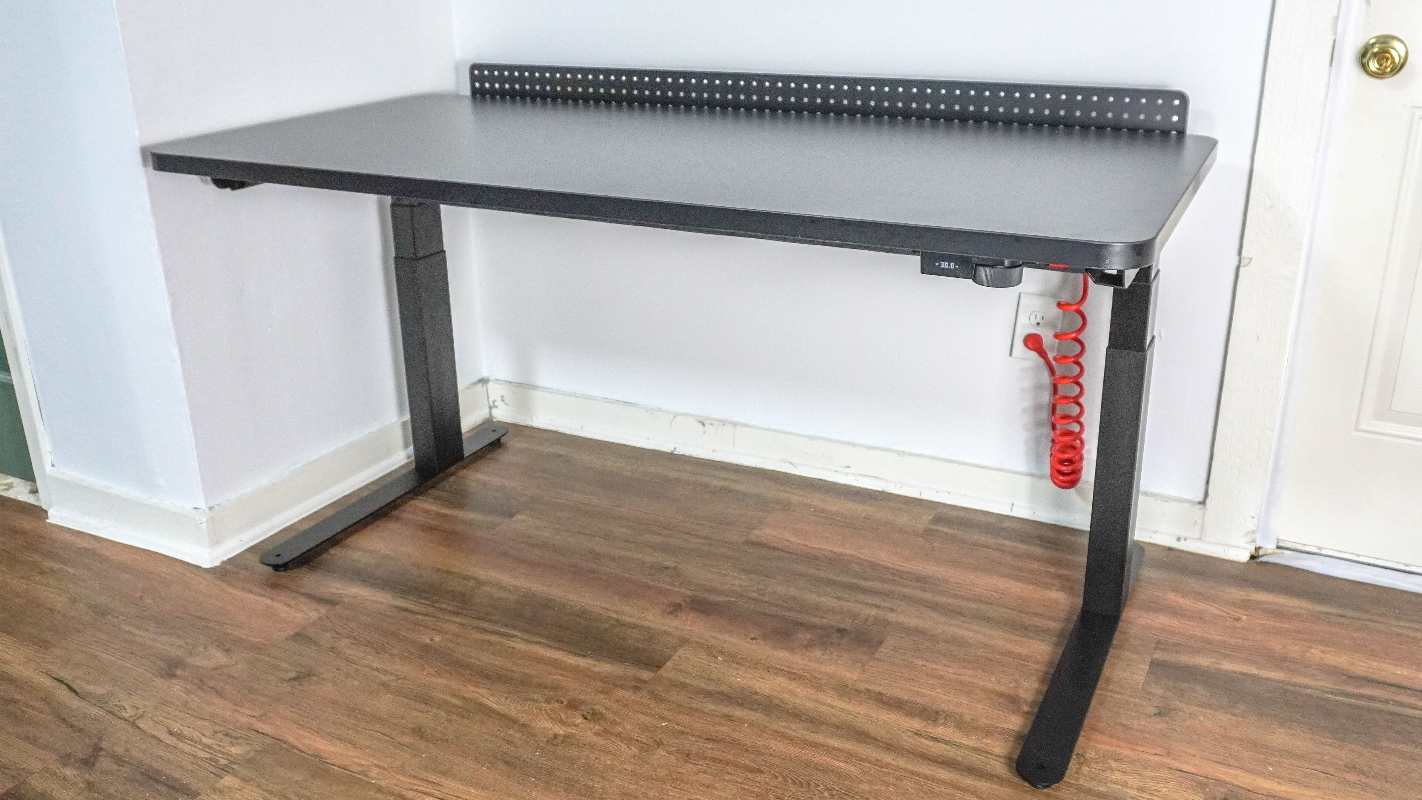 An angled shot showing the Herman Miller Coyl Gaming Desk in black in a corner