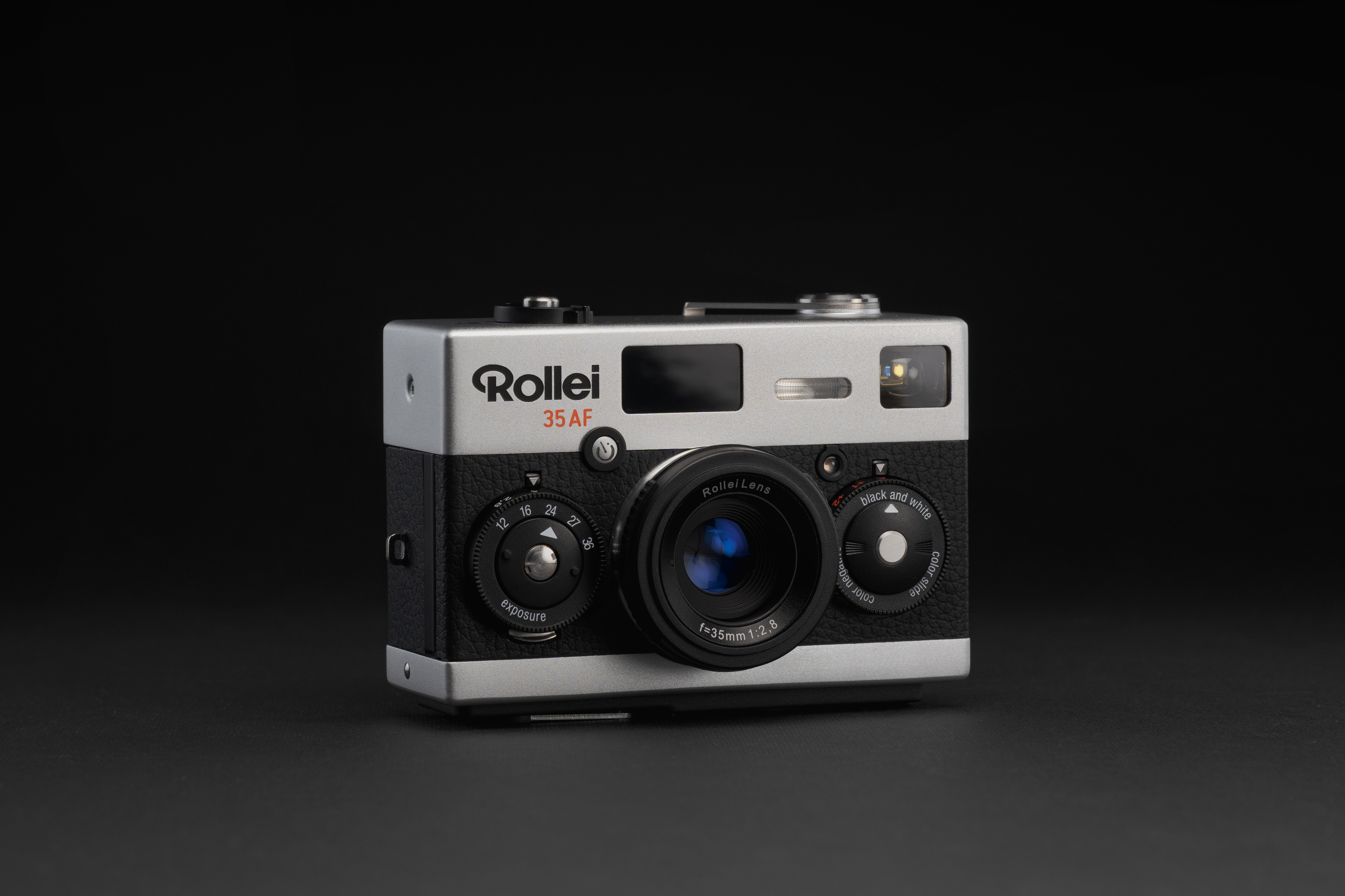 Rollei 35AF film camera on a grey surface and black background