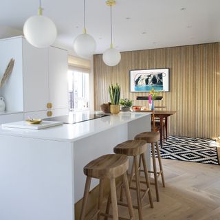 Kitchen with island and panelling against entire wall