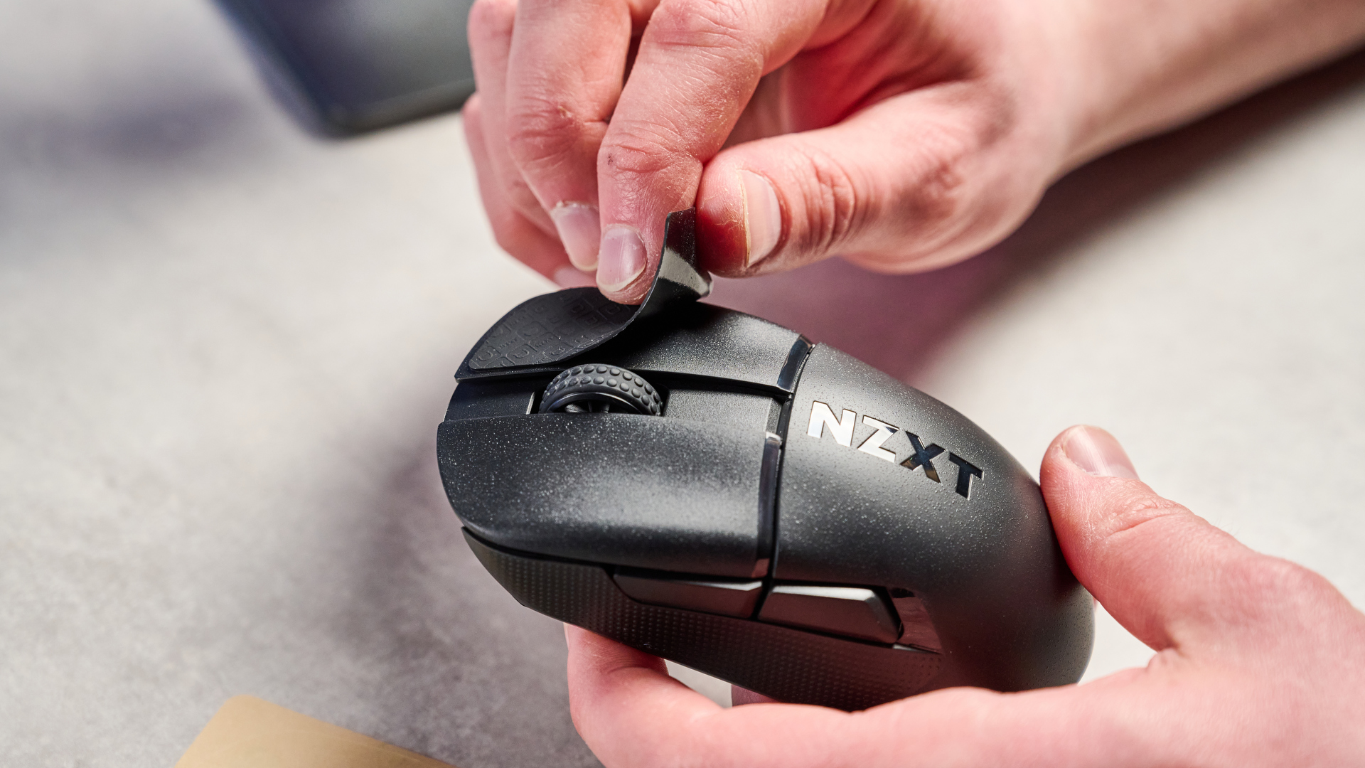 A black NZXT Lift Elite Wireless gaming mouse