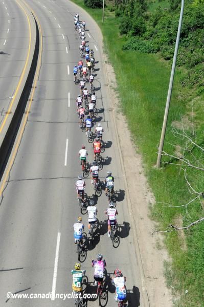 The peloton strung out on a climb.