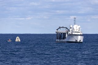 An uncrewed SpaceX Crew Dragon capsule used during the Demo-1 test mission seen in the ocean after it splashed down in March 2019.