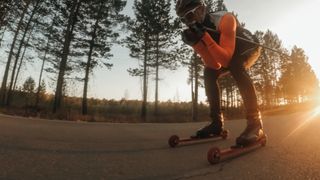A roller skier practices his tuck