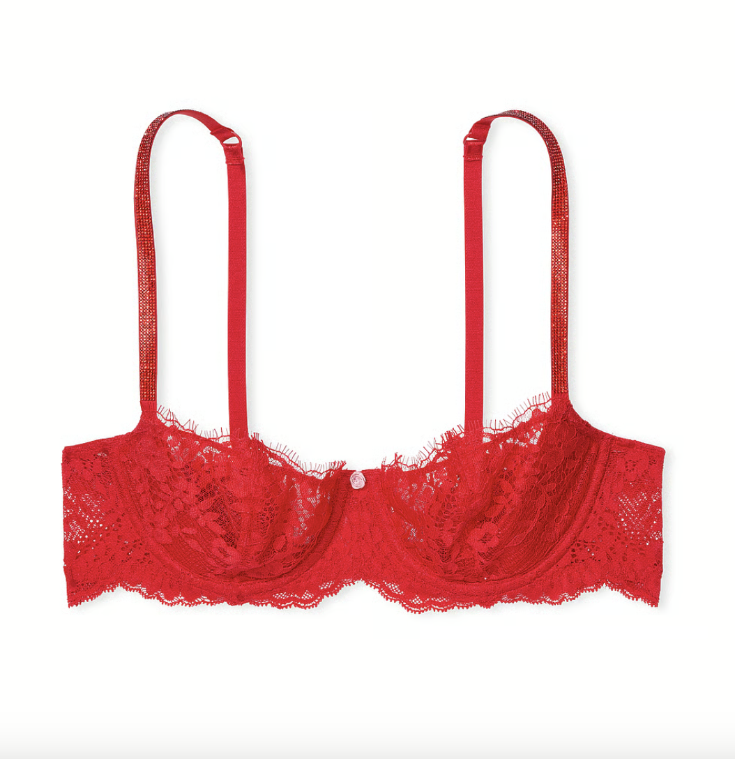 A red pointed bra by Victoria's secret against a simple backdrop