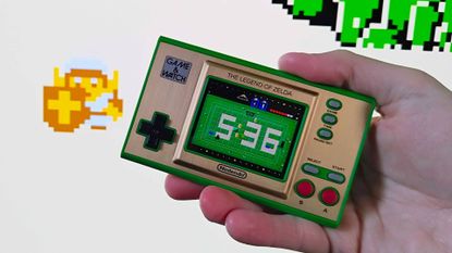 Hand holding Zelda Game and Watch handheld with gameplay featuring Link in white outfit in backdrop.