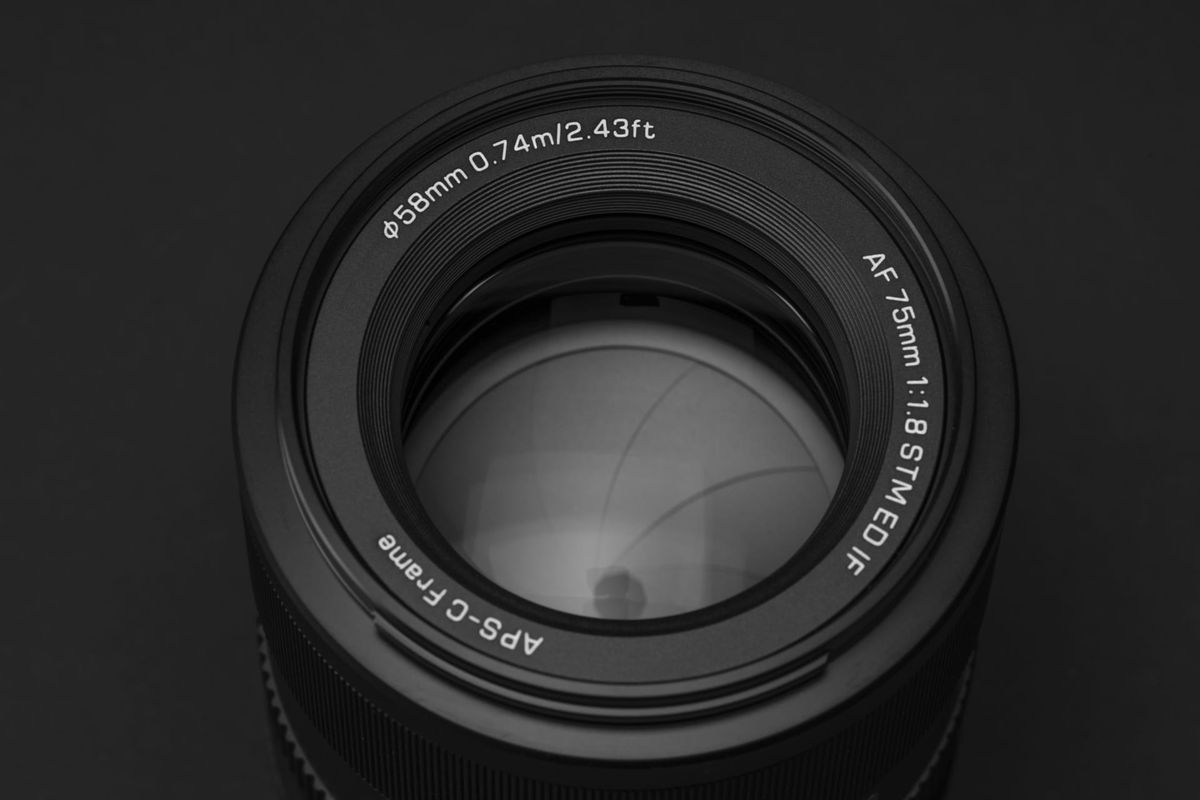 Close up of the Viltrox AF 75mm F1.8 EVO lens on a black background