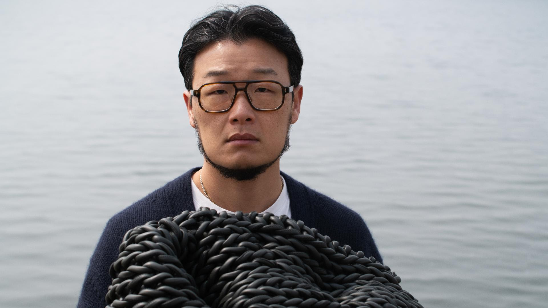 Kwangho Lee holding woven leather object