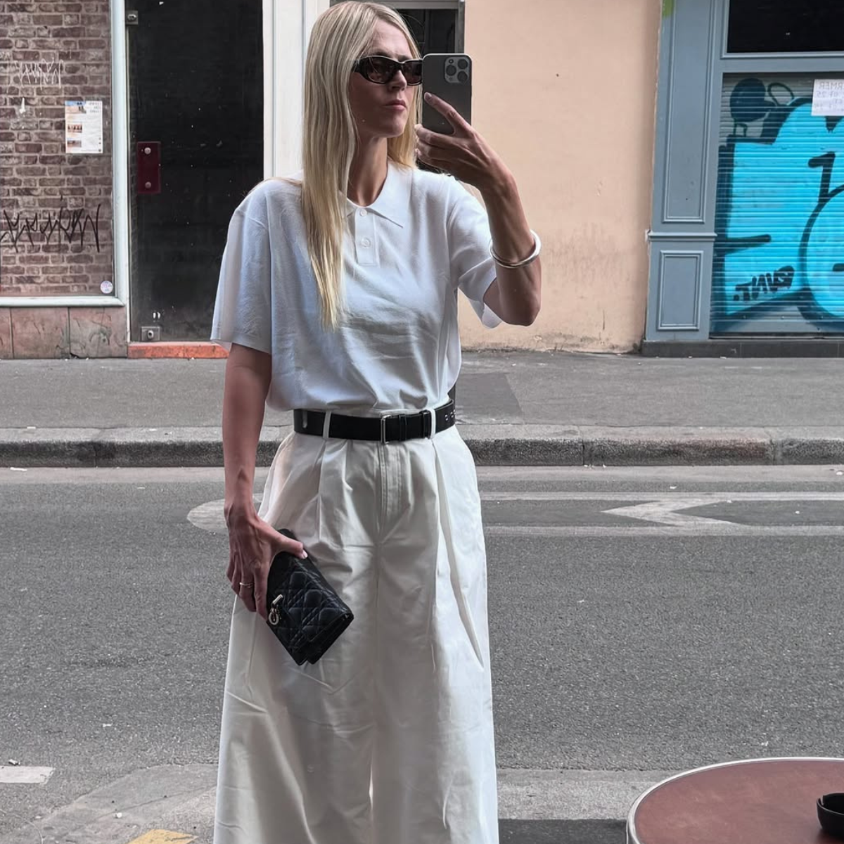 woman wearing white trousers black belt fall outfits 2025