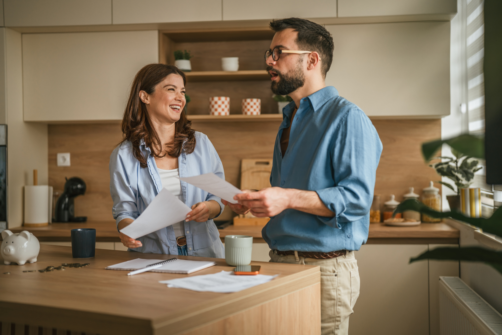 Happy couple managing home finances and planning budget