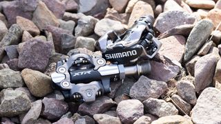 Shimano XTR and PD-M520 pedals sitting on rocks