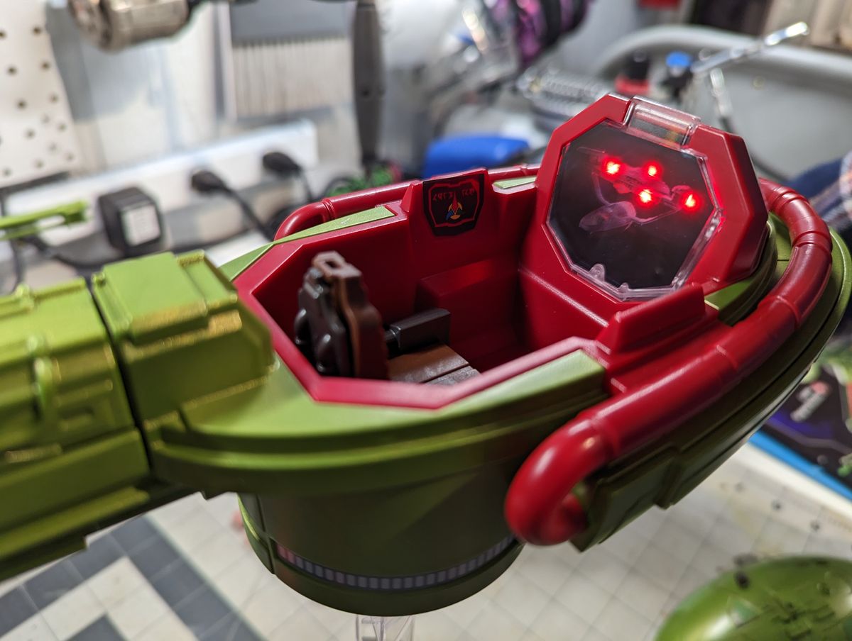 a child assembles a klingon bird of prey on a workbench