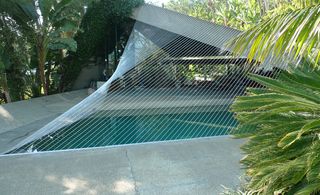 Cords stretched from the edge of the pool to the roofline, creating a triangular feature