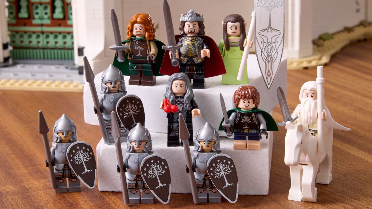 Lego Minas Tirith on a wooden surface, with multiple minifigures visible