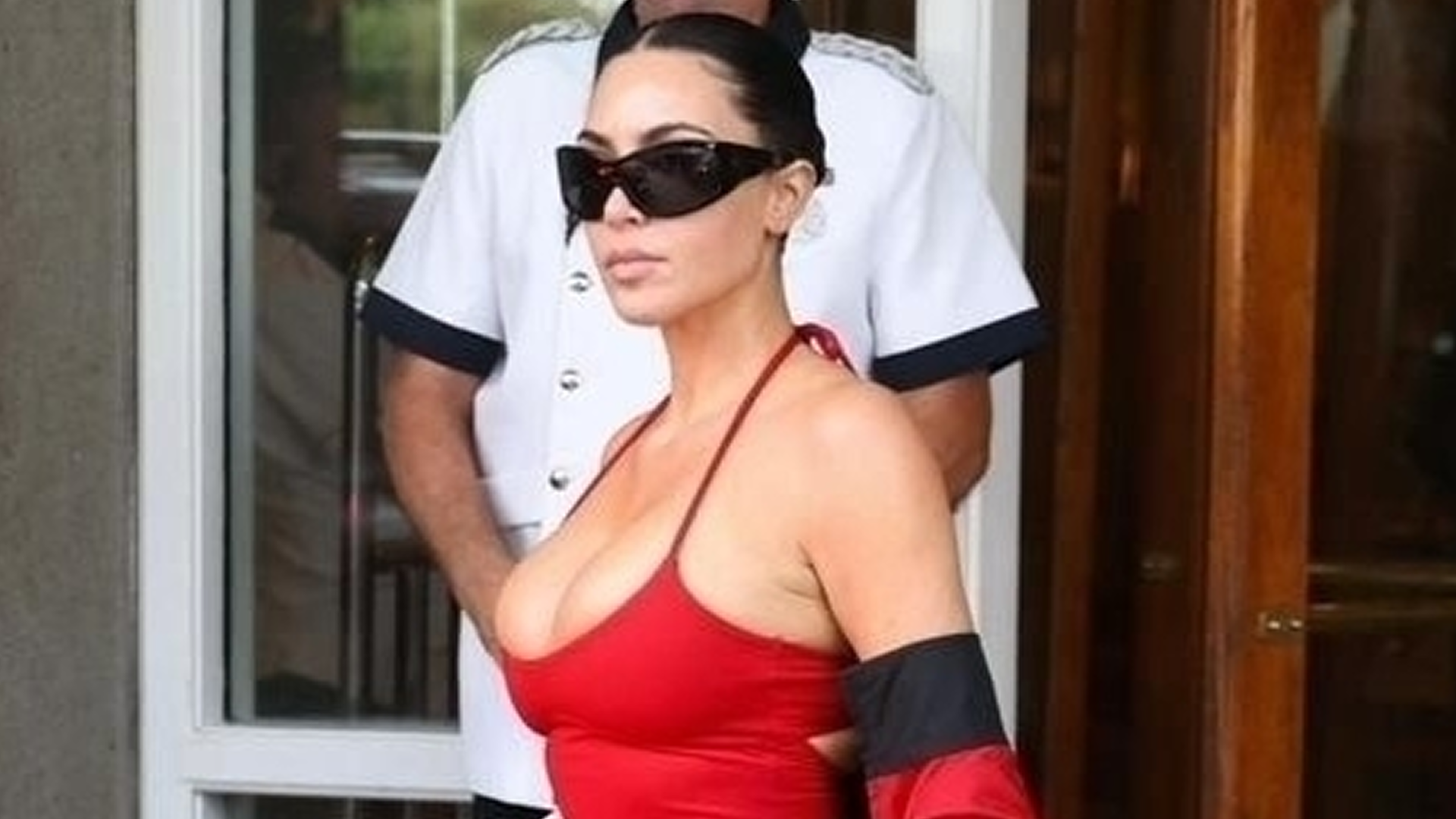 Kim Kardashian styled baggy cargo pants with socks and flip flops 