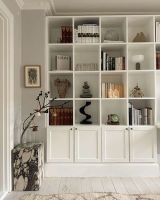 White bookcase with decor and books