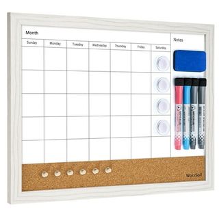 A white framed, wall mounted whiteboard with a corkboard strip on the bottom. Dry erase markers and an eraser hung on one side