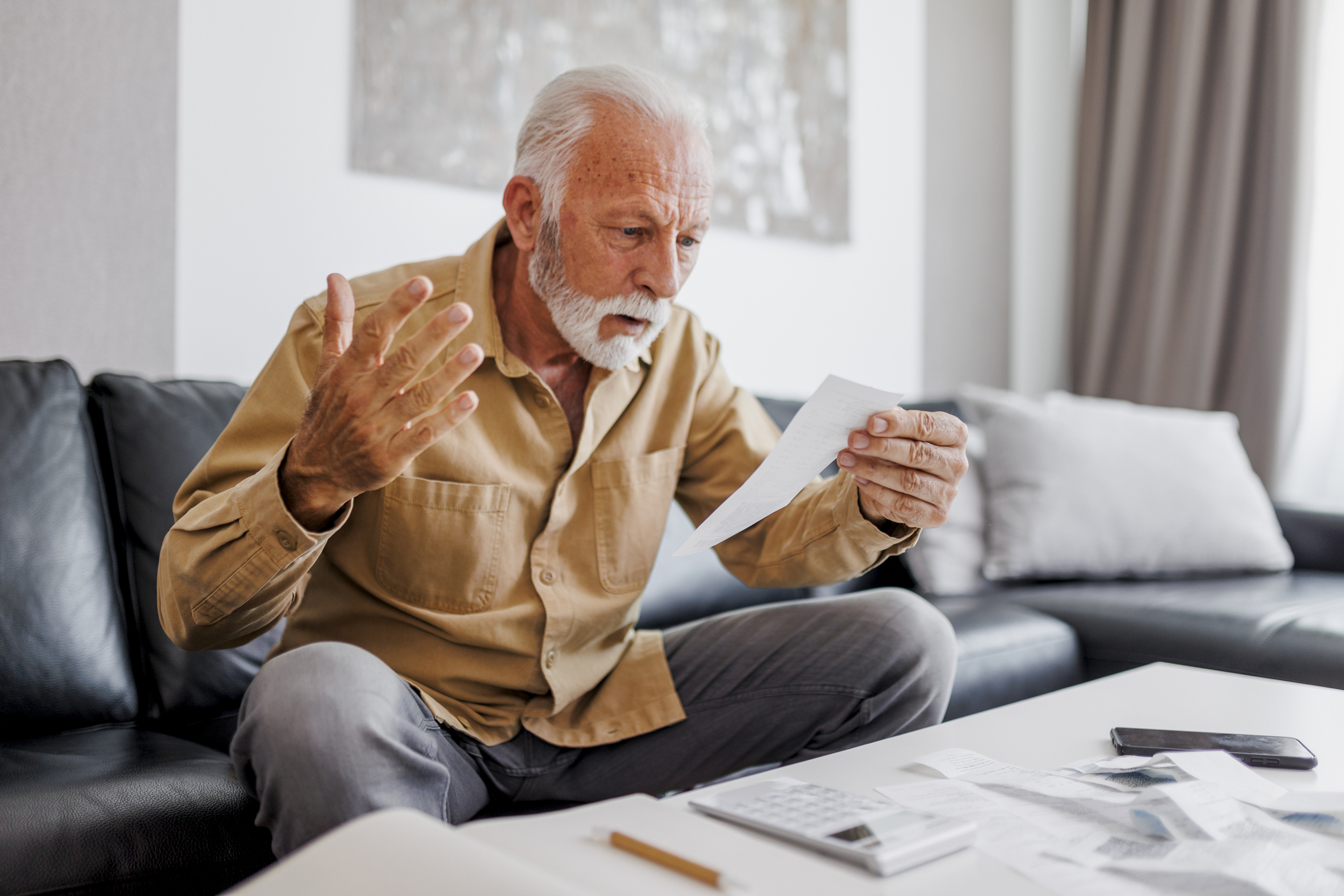 Older man looking at bill