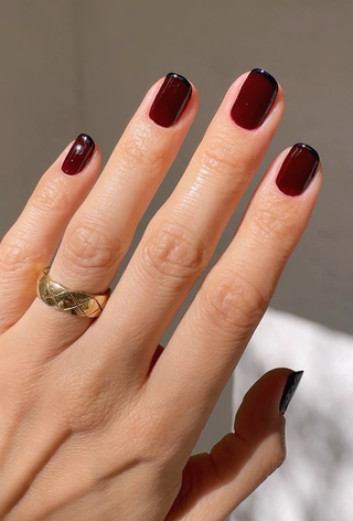 A burgundy manicure with navy blue tips by Betina Goldstein.