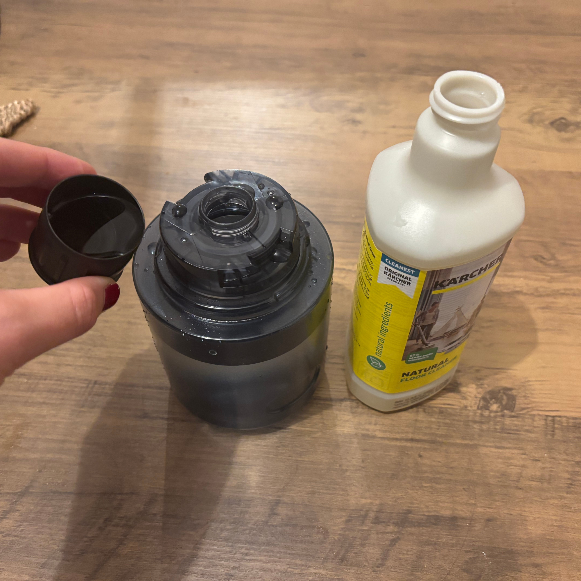 grey clean water tank next to cleaning solution