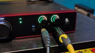 Two cables plugged into the headphone sockets of a Focusrite Scarlett 18i20 4th Gen