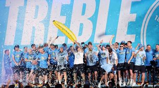 Manchester City players celebrate winning the treble in a party in Manchester in June 2023.