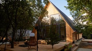timber clad house with lots of glazing and decking