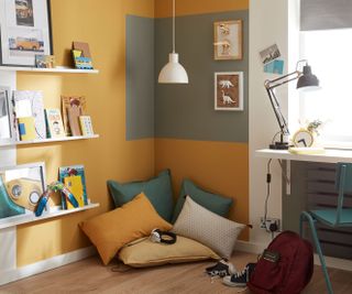 bedroom with cosy corner with cushions and yellow walls