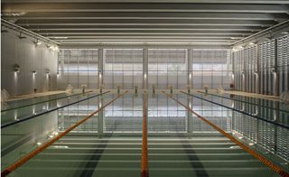 Indoor swimming pool view with dim lighting