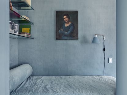 A monochromatic blue alcove bedroom