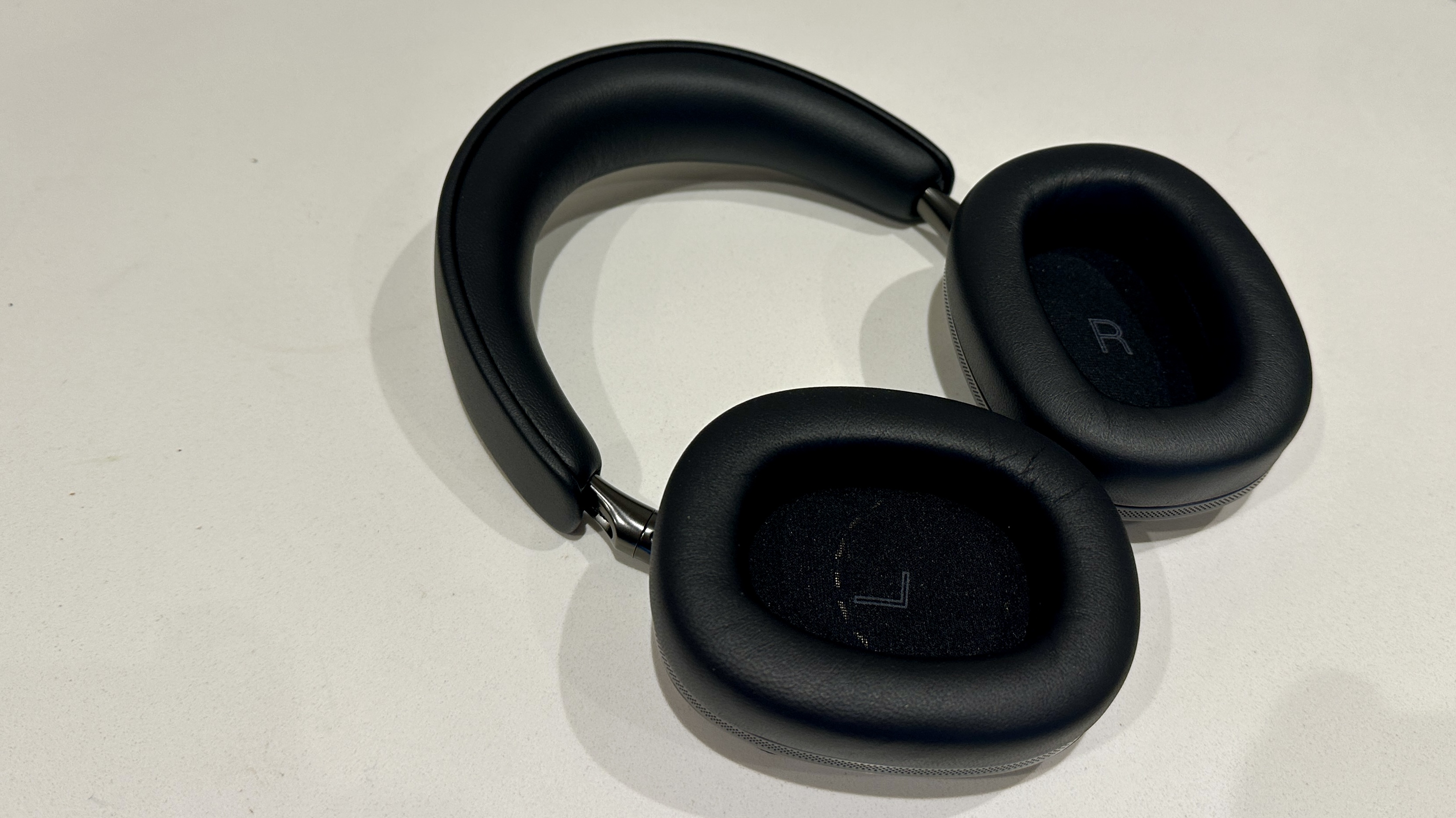 The earcups of the Bowers &amp;amp; Wilkins Px8 S2 over-ear ANC headphones on a white surface
