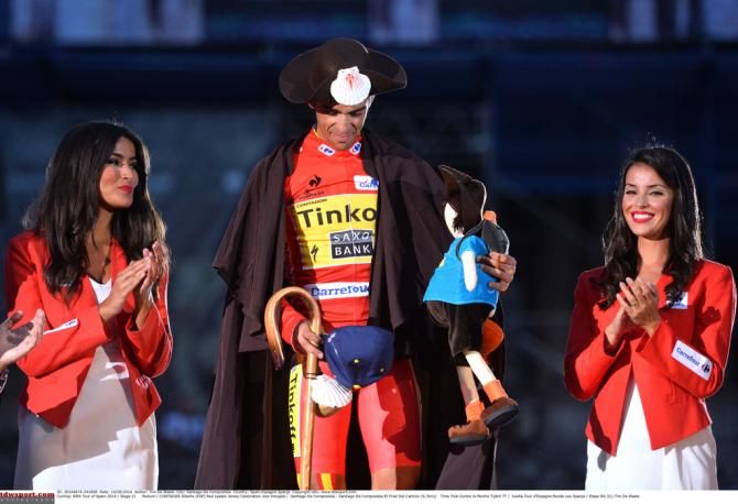 Alberto Contador (Tinkoff-Saxo) decked out in the traditional pilgrims cape, hat and staff on the podium