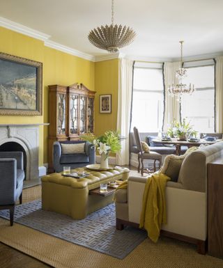 Yellow living room, yellow footstool, wooden dining table