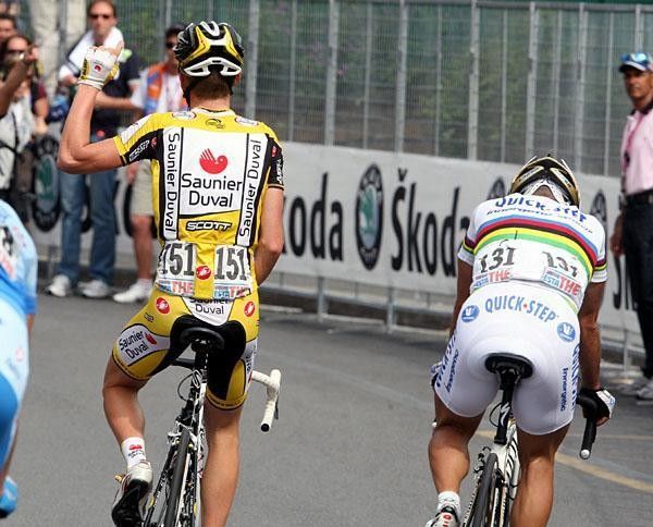 A joyful Ricc&ograve; rides next to a dejected Bettini.