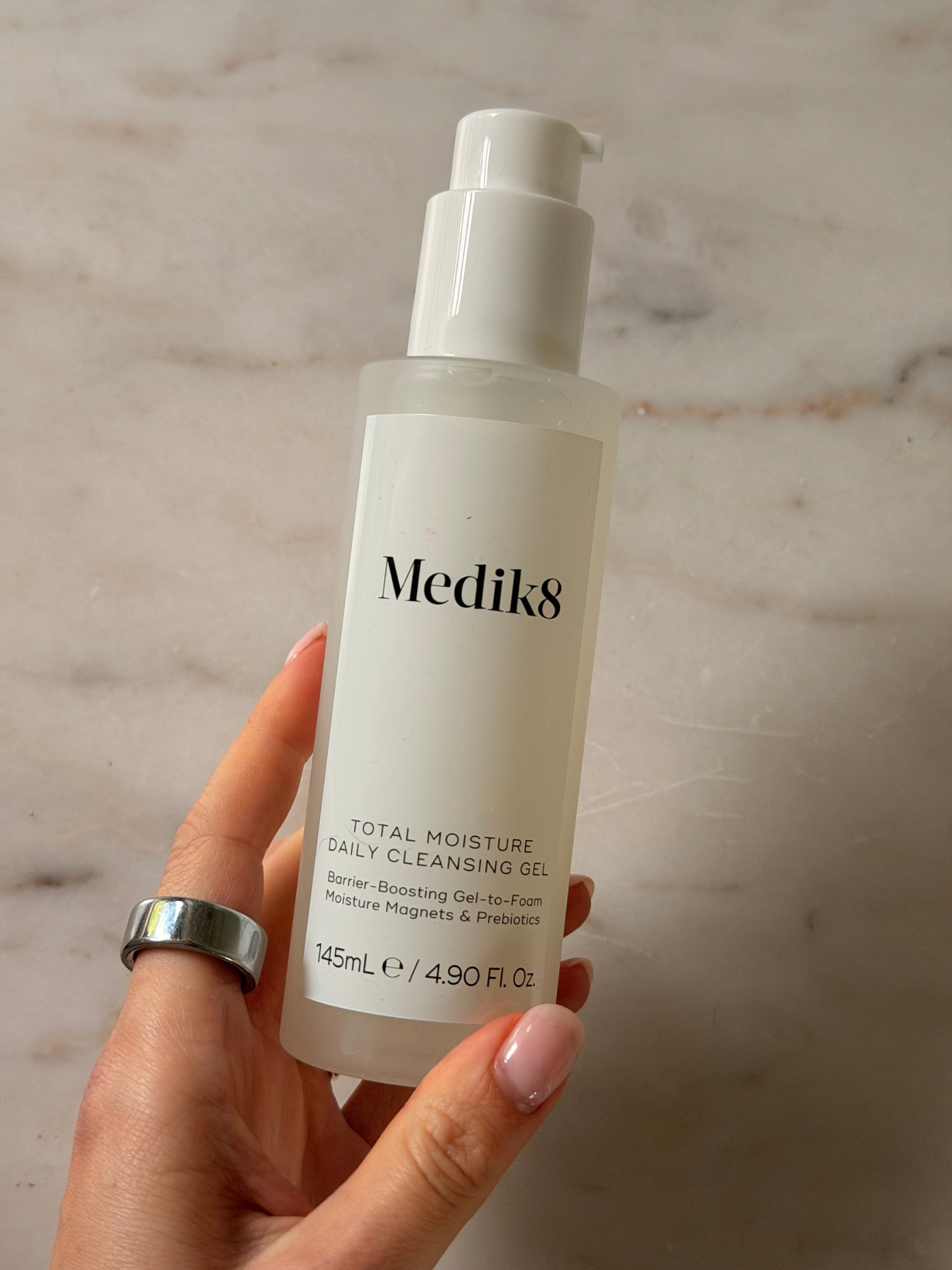 Freelance beauty editor Grace Day holding a bottle of
