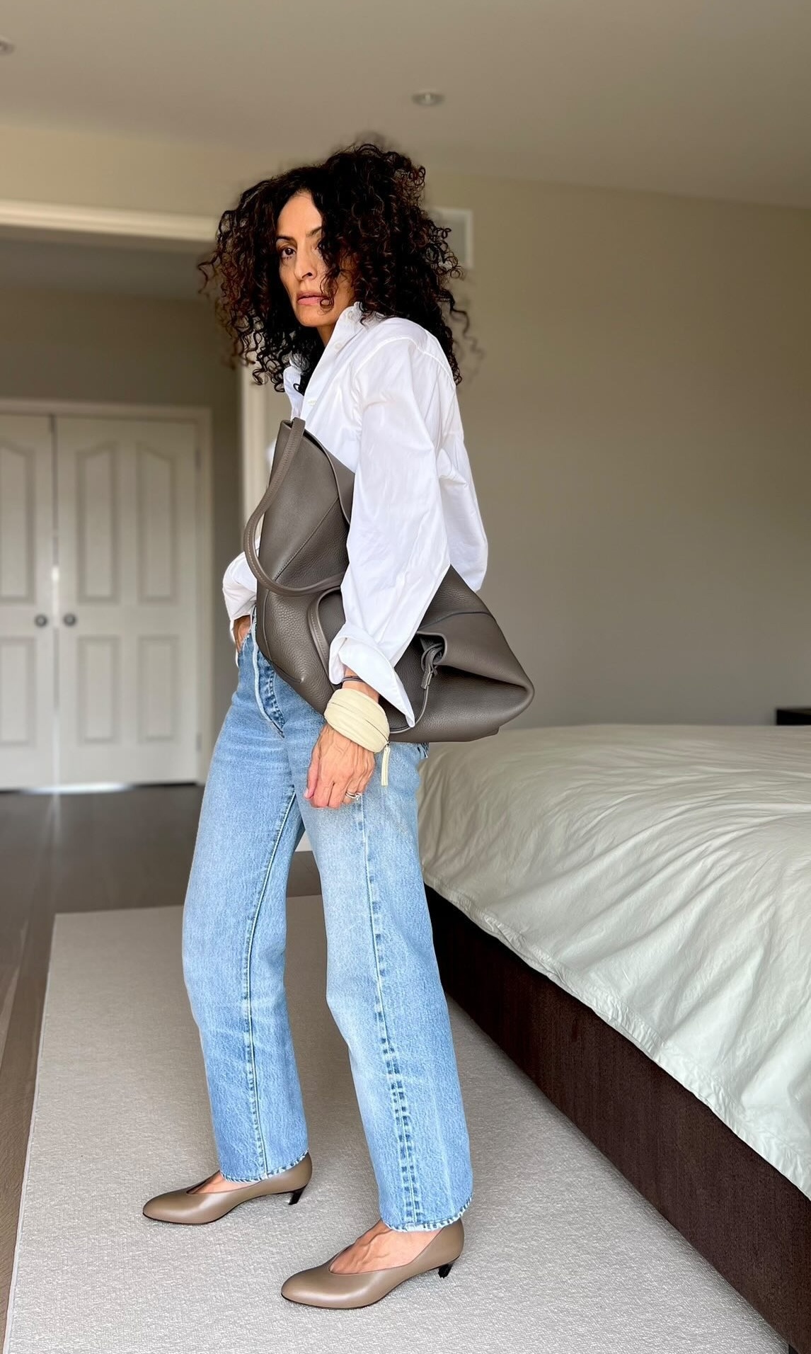 An influencer wearing a pair of almond-toe shoes.