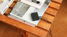 An Atonemo Streamplayer sitting on top of a hardback book on a wooden table 